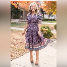 Our Rachel Dress By Current Air Is An Avara Exclusive You Don't Want To Miss. It Looks And Feels Like One Of Our Designer Pieces, But Without The Price Tag. The Mixed Print Is So Great! The Details On This Dress Are Perfection With Smocking At The Waist, Puff Sleeves, And Easy Midi Length. It's Silky Soft, And Oh So Chic! Purple Knee-length Midi Dress For Vacation, Purple Floral Print Midi Dress For Vacation, Purple Floral Midi Dress For Vacation, Vacation Purple Floral Print Midi Dress, Lavender Bohemian Short Sleeve Dress, Purple Floral Print Knee-length Midi Dress, Casual Lavender Knee-length Midi Dress, Lavender Short Sleeve Midi Dress Casual, Purple Short Sleeve Midi Dress