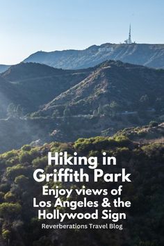 the hollywood sign is on top of a hill with trees and mountains in the background