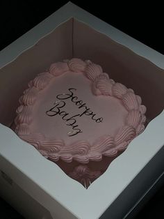 a pink cake in a white box with the words happy baby written on it's side