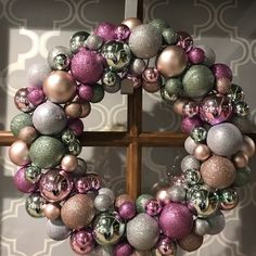 a wreath with ornaments hanging from it