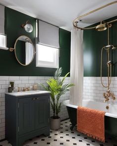 a bathroom with green walls and black and white tiles