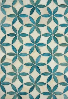 an artistic tile design in shades of blue and white, with circular leaves on it