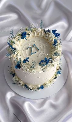 a white cake with blue flowers on it