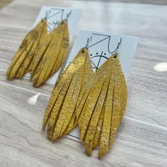 Genuine sparkle yellow toned metallic dazzle leather cut into two elongated fringe layers on nickel free hardware. This listing is for one pair of earrings. Photos depicting multiple pairs are for styling purposes only. The last photo shown is of another Alexis style earring for measurement purposes. Trendy Gold Tassel Earrings With Fringe, Trendy Gold Fringe Earrings, Adjustable Gold Tassel Earrings With Fringe, Yellow Fringe Jewelry For Party, Adjustable Gold Tassel Earrings For Party, Elegant Yellow Fringe Earrings, Leather Cuts, Yellow Tones, Fringe Earrings