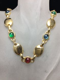 "Gorgeous David Grau necklace all done on brilliant gold plated metal. This necklace consists of eight flawed emerald, sapphire blue and ruby red round Cabochons with large oval brilliant gold discs between each one. Measuring 18\" by 5/8\". ABSOLUTELY GORGEOUS!" Gold Disc, Gold Tone Necklace, Choker Necklaces, Sapphire Blue, Fashion Jewellery, Ruby Red, Blue Sapphire, Necklace Etsy, Choker