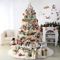 a decorated christmas tree in a living room with presents on the floor and decorations around it