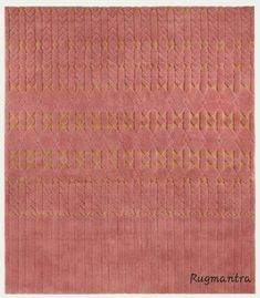 a pink rug with gold lines on it