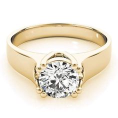 a yellow gold engagement ring with a round brilliant diamond in the center, on a white background