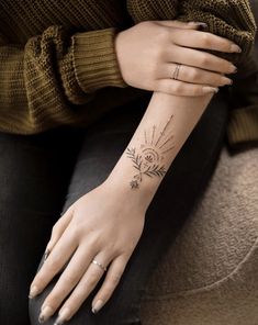 a woman's arm with a tattoo on it