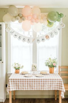 a table with balloons and plates on it