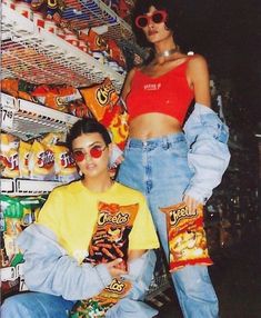 two people are posing in front of some snacks