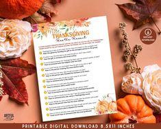 a thanksgiving printable is shown with flowers and pumpkins on the table next to it