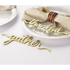 a table with plates and napkins that have the word grateful on them, along with a bow tie