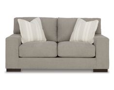 a gray couch with two white pillows on it