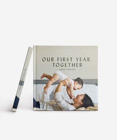 the first year together book with a pencil next to it and an image of a father holding his daughter