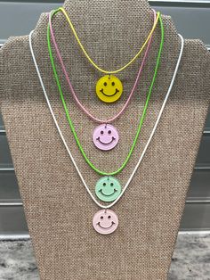 Smiley face feel good collection 😀🥰 A happy face acrylic pendant necklace is an adorable accessory that will make anyone smile. It features an acrylic pendant with the iconic smiley face design in various colors like red, pink, green or blue see all the colours to choose from.  The acrylic pendant is attached to an 16 inch long (19 inches end to end including lock and extra chain) coloured cotton waxed cord chain  which can be worn around the neck for a trendy look. This pendant necklace would White Playful Friendship Necklace, Playful White Friendship Necklace, Trendy Smiley Face Adjustable Necklace, Trendy White Necklaces For Friendship, White Trendy Necklace For Friendship, Playful White Necklace For Everyday, Playful White Everyday Necklaces, Face Necklace, Colorful Accessories