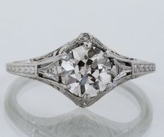 an antique style diamond ring with filigree accents