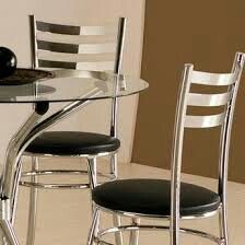 a glass dining table with four chairs around it