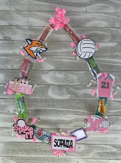 a wreath made out of stickers and other items on a wooden surface with the word spring