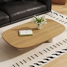 a living room with black leather couches and a coffee table in the middle of it