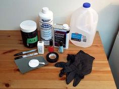 a wooden table topped with lots of cleaning supplies