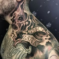 a man with tattoos on his chest and shoulder