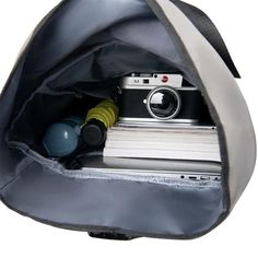 a camera and some books in a bag