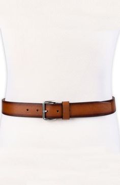 Burnished edges adds a rustic appeal to a stylish leather belt fitted with a soft rounded buckle for a casual finish. 1 1/2" belt width Leather Imported Leather Belt With Buckle Closure For Fall, Casual Brown Belt For Fall, Classic Brown Leather Belt Buckles, Casual Brown Belt With Buckle Closure, Classic Adjustable Brown Belt Buckle, Casual Brown Woven Leather Belt, Formal Leather Belt With Gold-tone Hardware, Brown Woven Leather Belt, Cole Haan