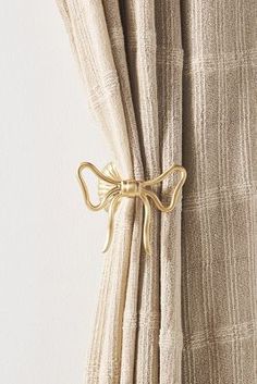 a curtain with a gold bow tie on it