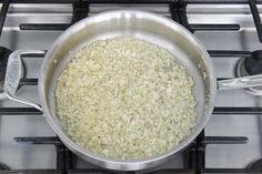 a pan filled with rice sitting on top of a stove