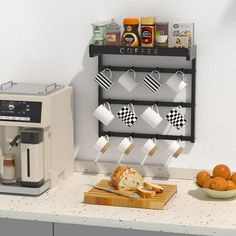 a coffee maker sitting on top of a counter next to oranges and other items