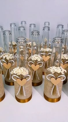 there are many empty glass bottles with hearts on the top and flowers in the bottom