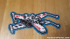 a close up of a piece of art made out of legos on a wooden floor