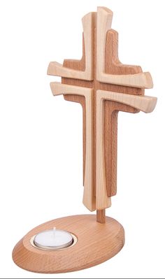 a wooden cross on a stand with a candle in the center and a white background