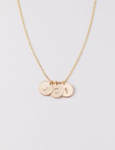 Small discs necklace - a dainty, classic, and minimalist necklace that can be personalized with one or several of the initials of your most favorite people. D E T A I L S * Disc size is approximately 9 mm in diameter, 0.9mm thick * Available in 14k gold fill, sterling silver, or 14k rose gold fill * This listing is for one necklace P R O M O T I O N * Bridesmaids gifts: message us for a coupon code * New FACEBOOK or INSTAGRAM followers: follow us in the links below then message us for a 10% off Gold Charm Necklace With Custom Name And Round Pendant, Customizable Round Rose Gold Charm Necklace, Customizable Gold Round Disc Charm Necklaces, Personalized Dainty Medallion Charm Necklaces, Adjustable Gold Round Name Necklace, Customizable Gold Round Disc Charm Necklace, Personalized Dainty Medallion Charm Necklace, Round Hand Stamped Charm Necklaces For Birthday, Rose Gold Hand Stamped Charm Necklaces With Round Shape