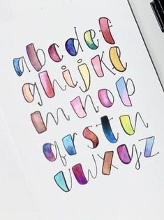 the letters are painted with watercolors on paper and placed next to each other