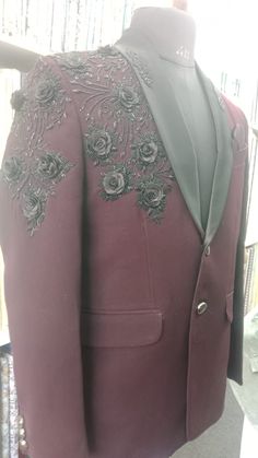 Unveil the embodiment of sophistication with our handmade embroidered designer suit jacket for men, where every stitch tells a story of master craftsmanship. This custom-designed floral blazer is the ideal choice for party, staying impeccably dressed at formal engagements, weddings, and a myriad of special events. Crafted with precision, its rich burgundy fabric seamlessly pairs with intricate black embroidery, making it a striking addition to any distinguished collection. The satin lapel enhances its elegance, ensuring you captivate attention effortlessly. Available across a diverse range of sizes, this blazer can be perfectly tailored to suit your bespoke measurements. Gift him or Elevate your style and shop today for this extraordinary piece of formal wear set.  Key Features: - Handmade Designer Embroidered Fitted Nehru Jacket, Designer Fitted Embroidered Nehru Jacket, Embroidered Tailored Bandhgala For Festive Occasions, Festive Embroidered Tailored Bandhgala, Traditional Tailored Sets With Resham Embroidery, Designer Fitted Nehru Jacket With Floral Embroidery, Traditional Formal Sets With Floral Embroidery, Formal Traditional Floral Embroidered Sets, Elegant Semi-formal Sets With Dabka Work