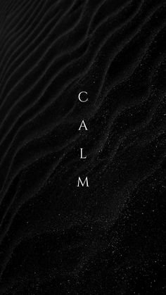 the words calm are written in white on black sand