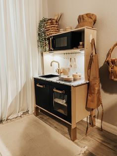 a kitchen with a sink, oven and cabinets in it next to a wall mounted pot rack