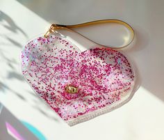 "Heart wristlet purse, cute kawaii handbag, small bag, glitter pink hearts, siren mermaid, pink and gold, kidcore, y2k, nostalgia, festival Easy to keep clean, practical. Our vinyl does not have a violet or blue color. size 27cm x 22 cm / 10.8 inch x 8.66 inch gold hardware We offer gift wrapping and beautiful personalized tickets. You can order our products for a gift and we will send them directly to the person you gave. Our bag are 100 % handmade. We are a legally operating company from Europe. Our bags are patented, 95% of our offer is vegan (free from cruelty), vinyl made of bags is recyclable and in our work we use environmentally safe accessories, for example, RAINFOREST ALLIANCE CERTIFIED. If you want to see more of my works, find me on instagram @ypsilonbags. Use the discount code Pink Clutch Wristlet As A Gift, Cute Handmade Party Bags, Pink Heart-shaped Bag For Party, Trendy Pink Glitter Bags, Cute Pink Coin Purse As Gift, Cute Pink Coin Purse For Gift, Kawaii Handbags, Kidcore Y2k, Y2k Nostalgia