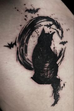 a black cat sitting on top of a person's back with bats flying around it