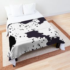 a bed with black and white paint splattered on it