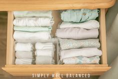 an open drawer filled with lots of folded clothes