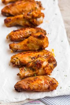 chicken wings are lined up on a paper towel