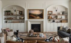 a living room filled with furniture and a fire place in front of a painting on the wall