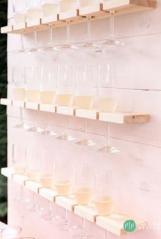 several wine glasses are lined up on the wall