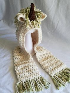 This unique hooded scarf will keep your little one warm and stylish. The Unicorn mane can be made in various colors. There are pockets on the scarf. Please message me for a custom order. The best thing about hand made items are that they can be customized to fit exactly. The hooded scarf can be made in any size. Unicorn Scarf, Soft Hats, Hooded Scarf, Cat Hat, The Unicorn, Rainbow Dash, Skull Cap Beanie, Chunky Yarn, Christmas Photos