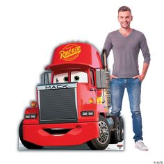 a man standing next to a red truck with the character mack on it's side