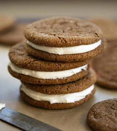 a stack of cookies sitting on top of a table next to a knife