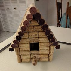 a house made out of wine corks sitting on top of a white countertop